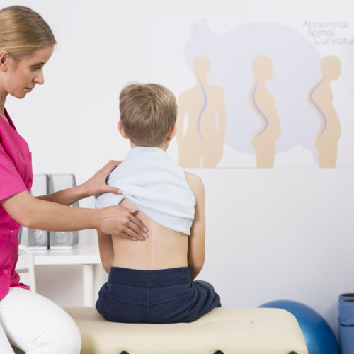 Doctor examining childs posture