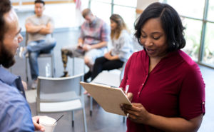 Mid adult therapist asks veteran questions before therapy starts