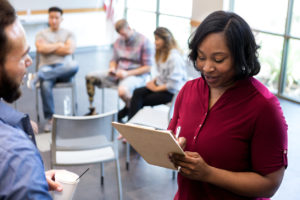 Mid adult therapist asks veteran questions before therapy starts