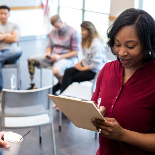 Mid adult therapist asks veteran questions before therapy starts