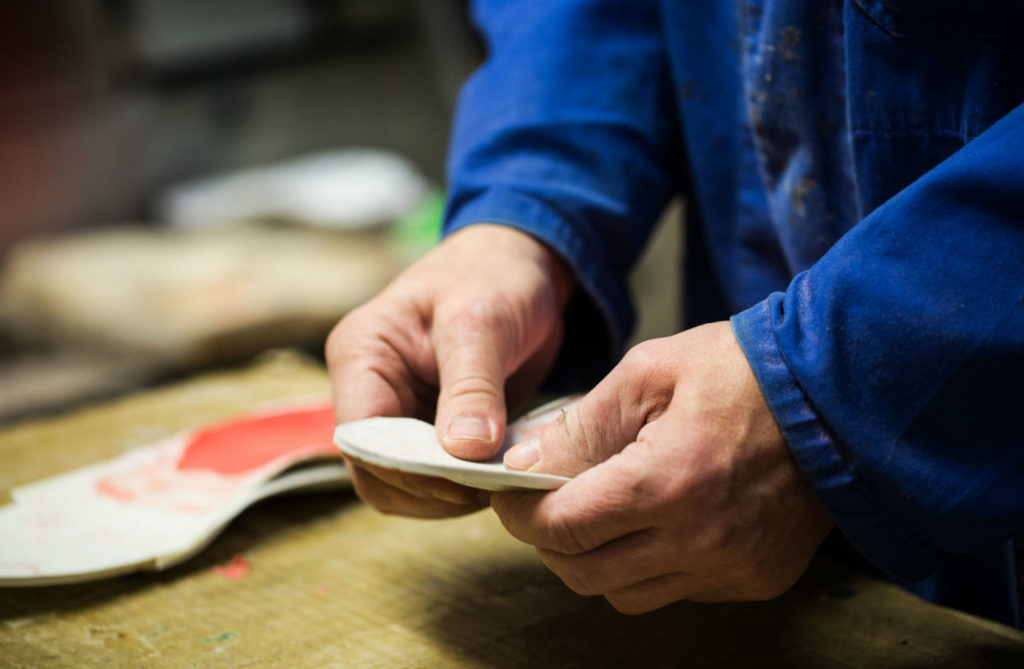 man holding pedorthotic inserts