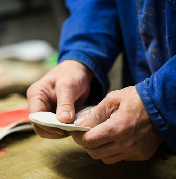 man holding pedorthotic inserts