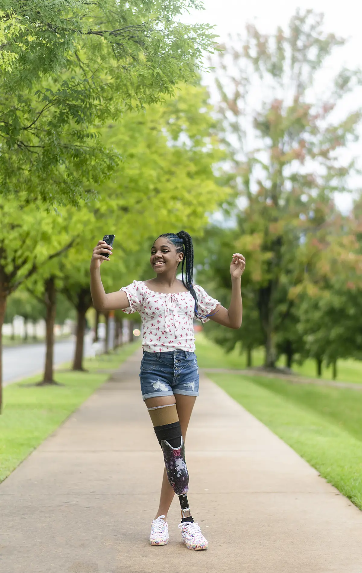 young woman with a prosthetic leg taking a selfie